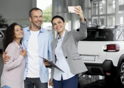 couple searching new car dealership