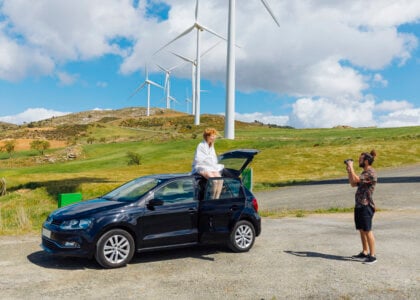 couple taking photos with car outdoors
